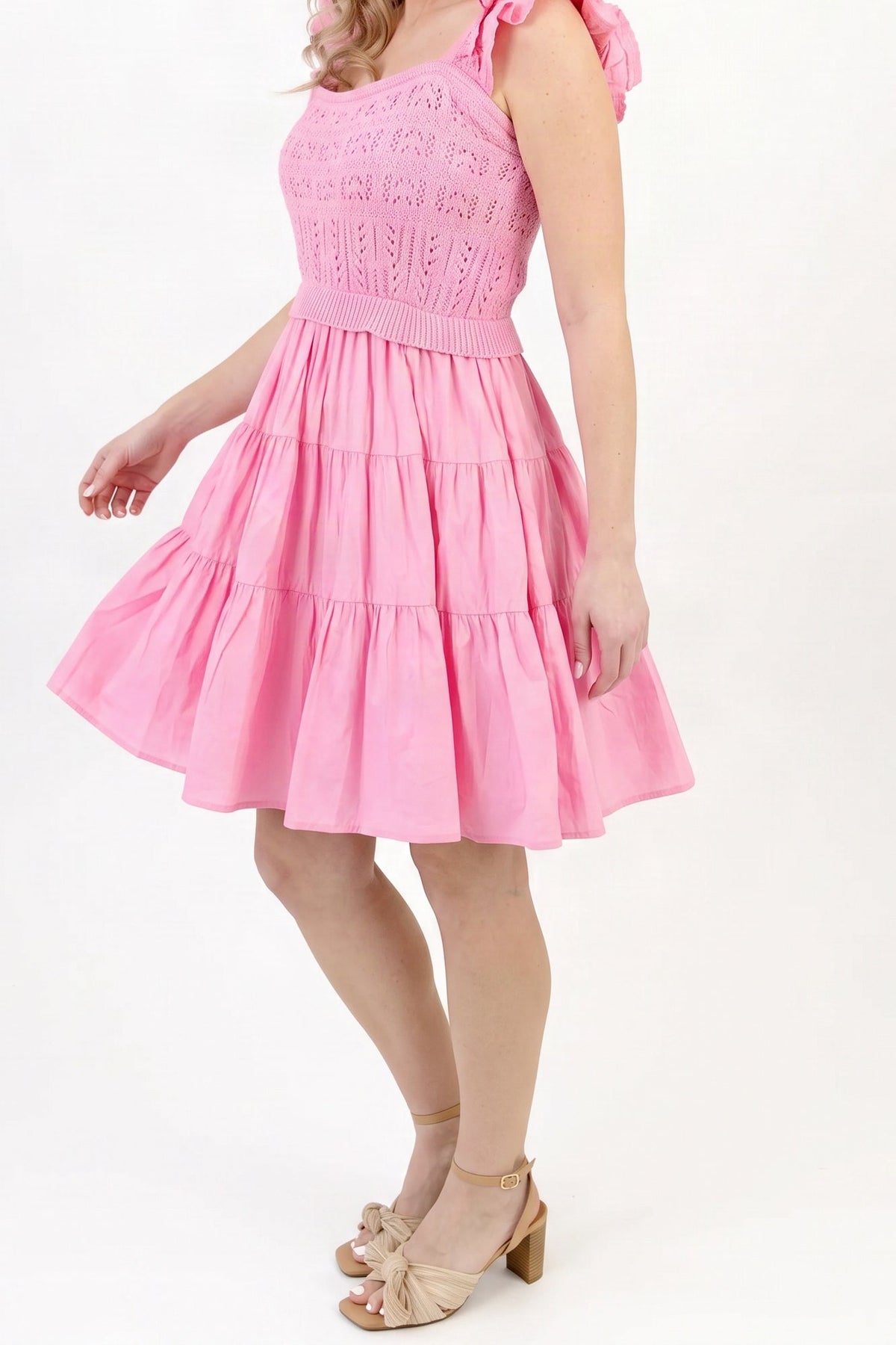 Model wearing the light pink crochet A-line dress, side view from the chin down