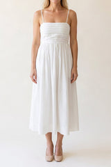 Model wearing the Love Actually white pleated midi dress, shown from the chin down