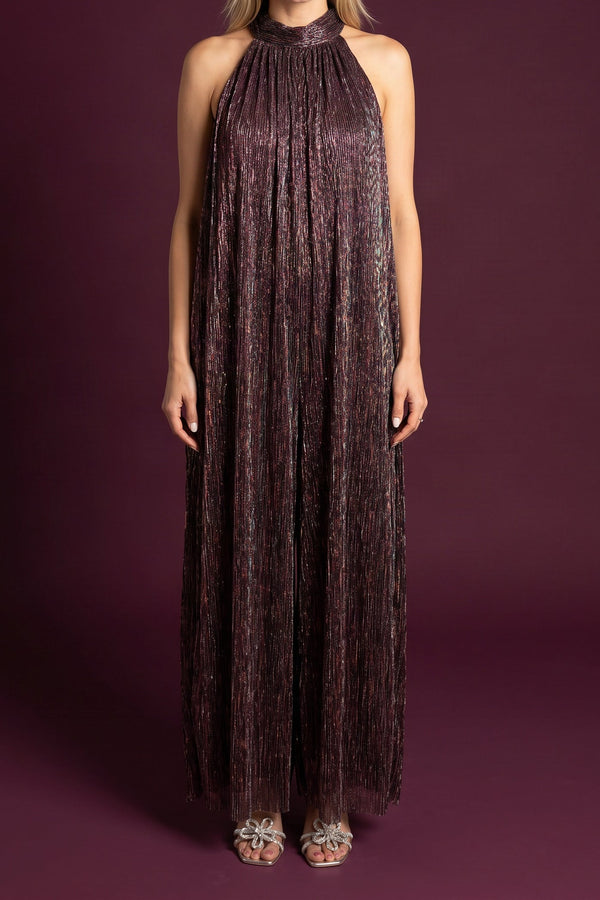 Model wearing the metallic plum halter-neck jumpsuit, shown from the chin down