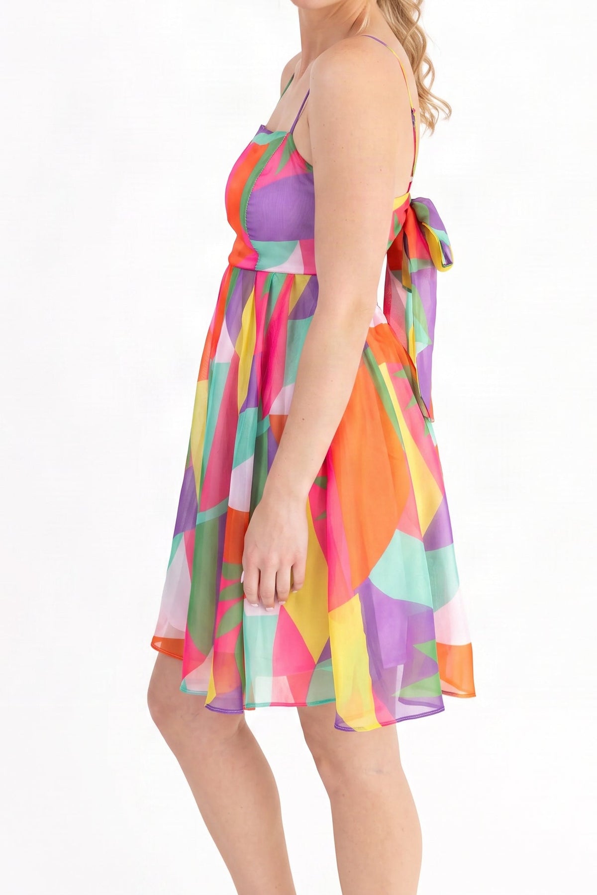 Model wearing the multicolour geometric print summer mini dress, side view from the chin down