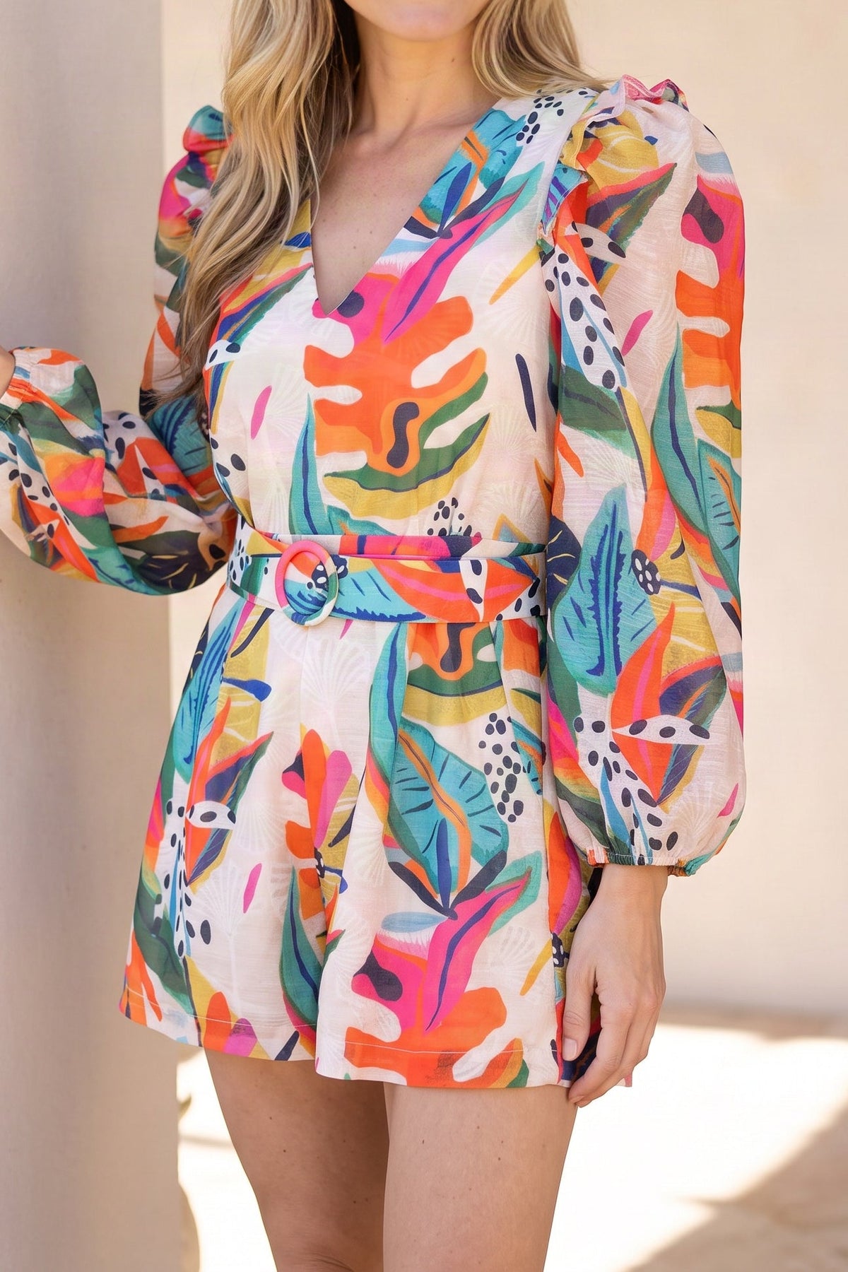 Model wearing the Sun-Kissed Serenity Belted Romper, shown from the chin down