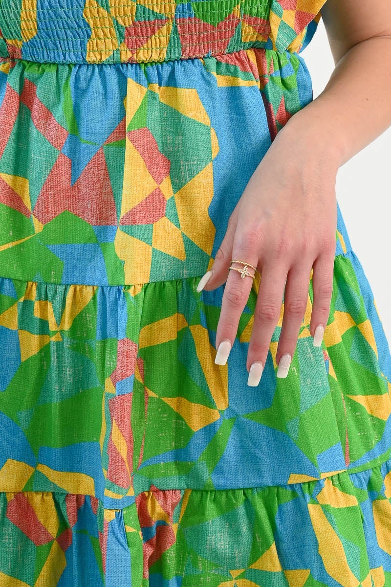 Nia Double Ring in a real photo, worn on the index finger with a printed dress, showing its true delicate size