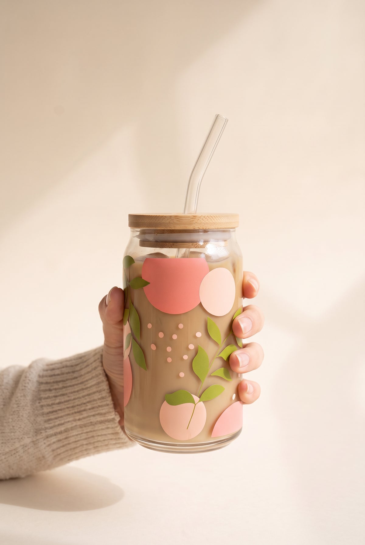 Adeline Spring Leaves Glass Cup held in one hand, showing the true size of the 16 oz can glass