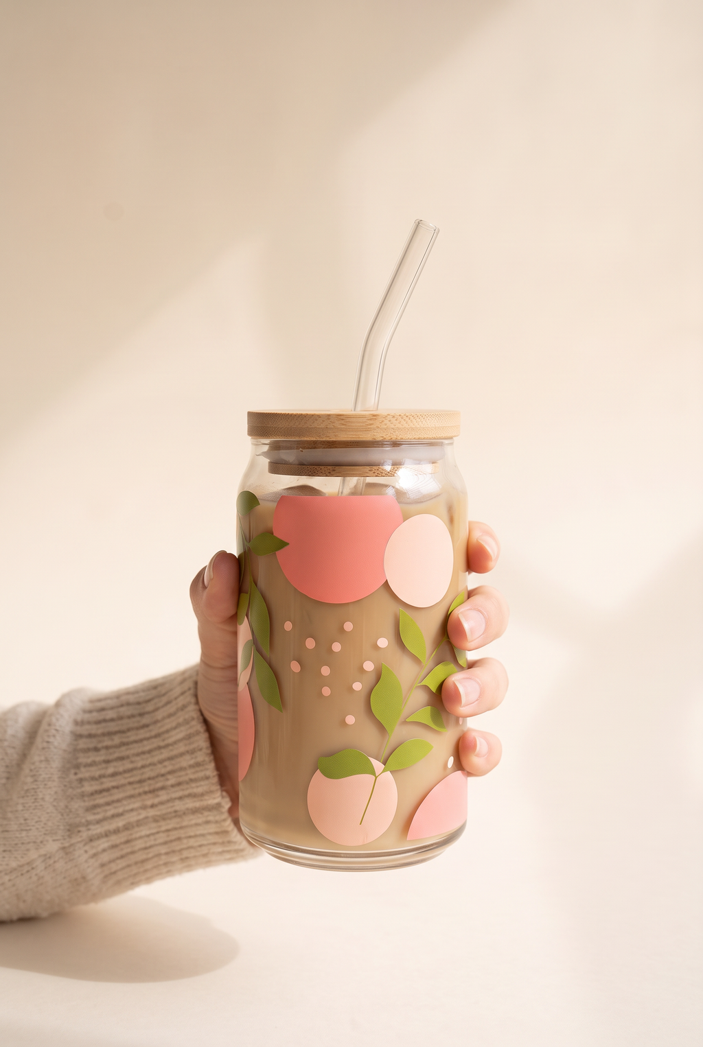 Adeline Spring Leaves Glass Cup held in one hand, showing the true size of the 16 oz can glass