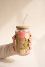Adeline Spring Leaves Glass Cup held in one hand, showing the true size of the 16 oz can glass