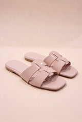 Brittany Flat Slide Sandal, pair of blush nude glossy patent slides with interlocking cage straps and a square open toe