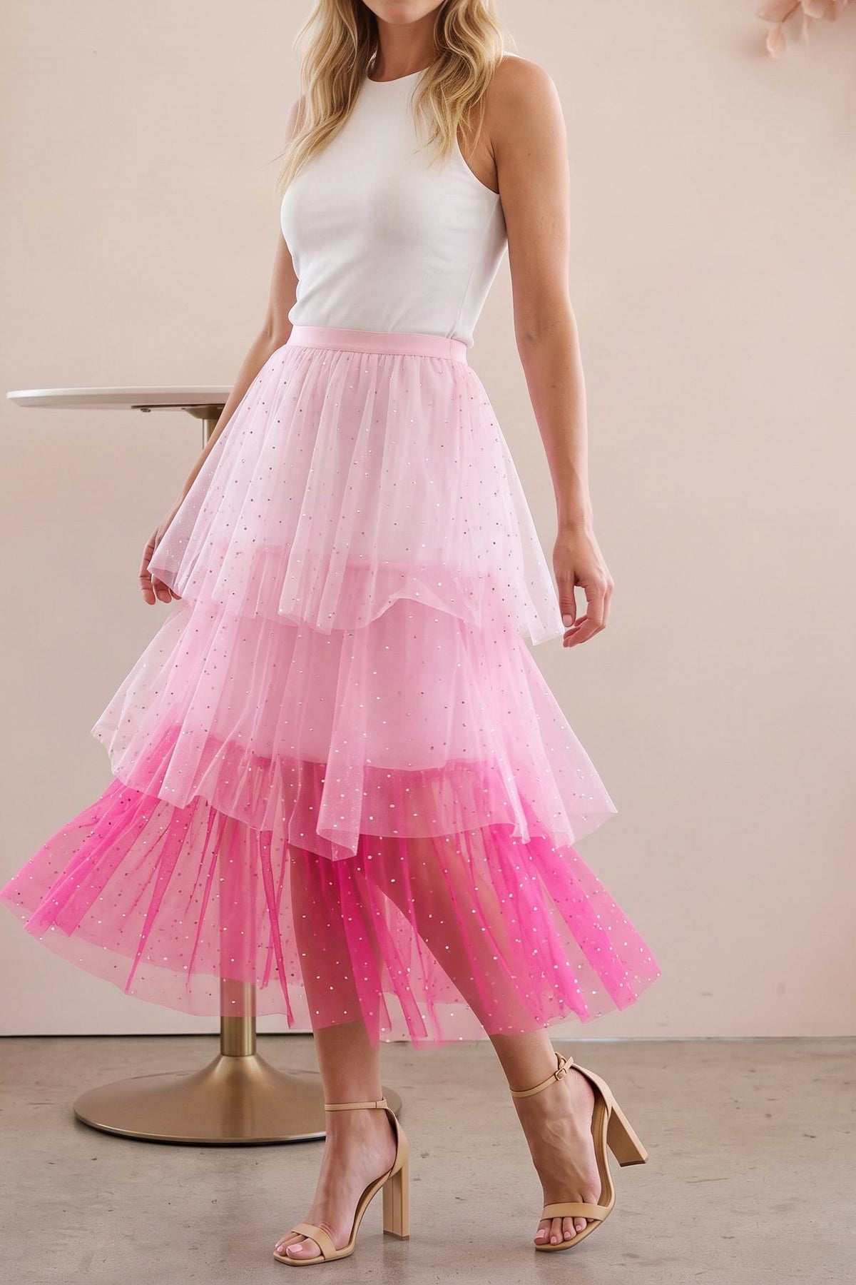 Pink layered tulle skirt worn in a cafe, shown from the chin down