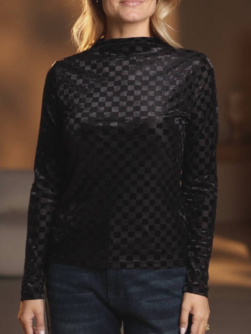 Elsa wears the Everybody Needs Someone velvet checker top during a subtle night-out turn and cuff adjustment.