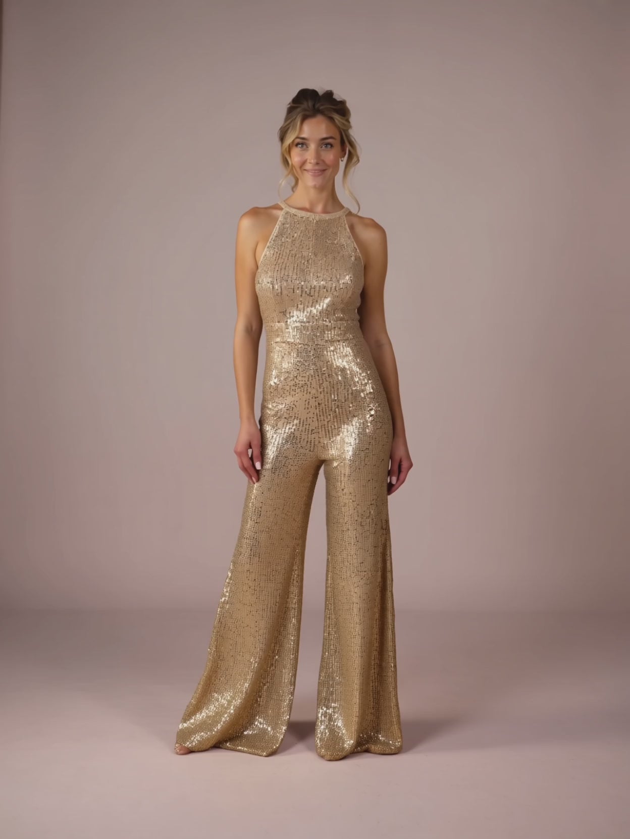 Elsa walking and quarter-turning in the gold sequin jumpsuit to show movement and sparkle.