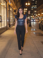 After Hours Bodysuit worn by Shweta at a city street at night, stepping forward and turning to show the back and the fit.