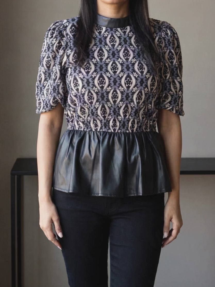 Shweta turns from front to side in the Last Night peplum top, showing the sleeve and peplum movement.