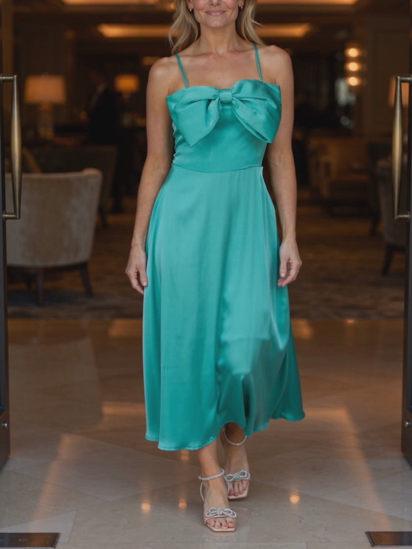 Turquoise Bow-tiful You Midi Dress moving through a formal evening setting with a fluid skirt swing.