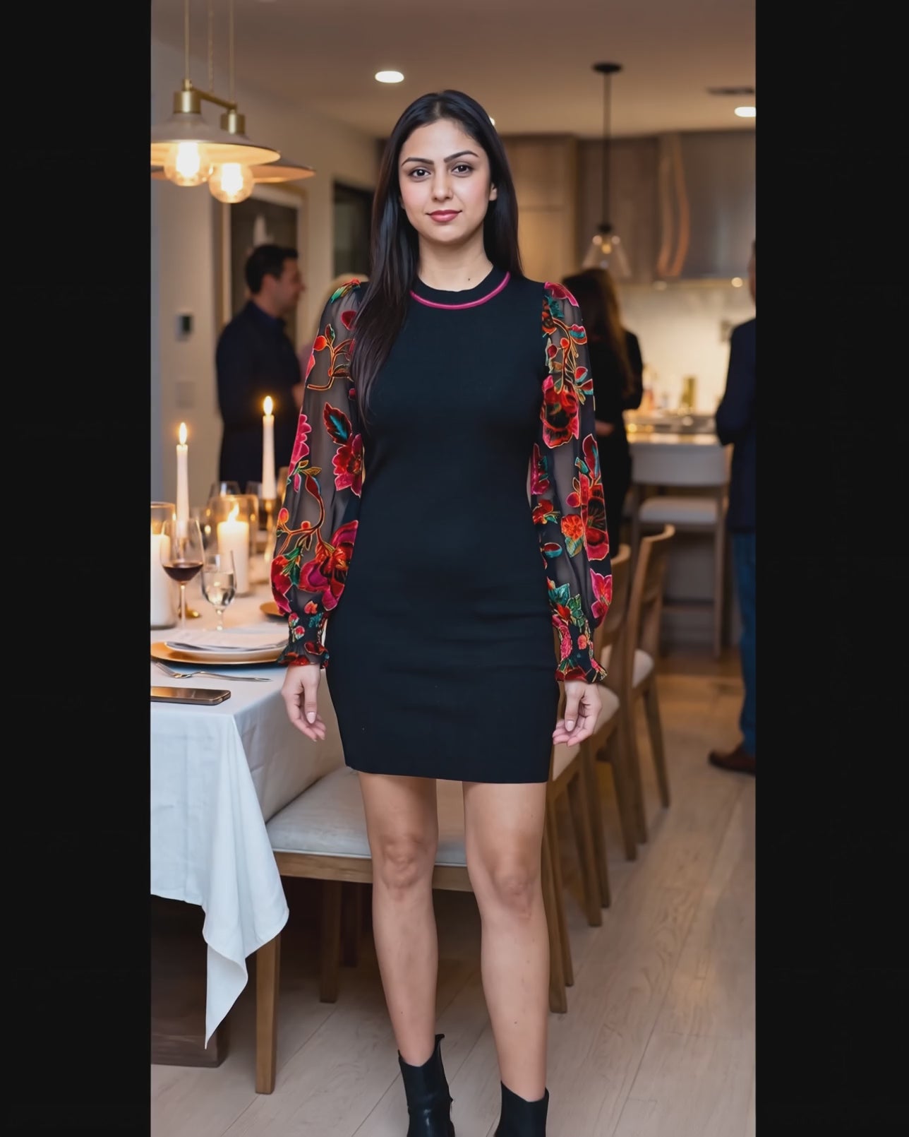 Shweta moving the floral sheer sleeves of You're My Favorite Sweater Dress at a dinner party.