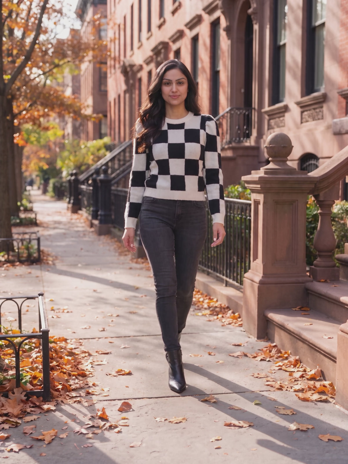 Checkmate Chic Knit Sweater with Puff Sleeves worn by Shweta at an autumn city street, stepping forward and turning to show the back and the fit.