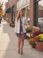 The navy floral short sleeve shift dress worn by Sofia at an autumn main street, stepping forward and turning to show the side and the fit.