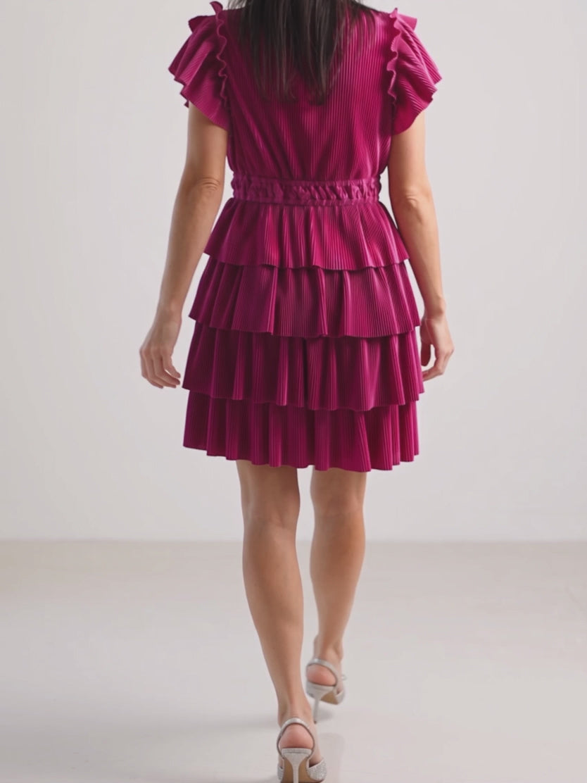 Five-second view of Shweta stepping and turning in the Small Magenta dress as the pleated tiers settle.
