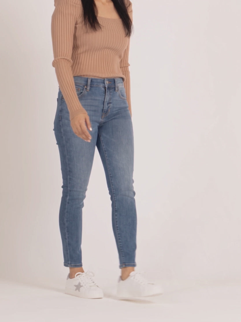 Bold Adventures Skinny Jeans moving through a natural walking stride on Shweta.