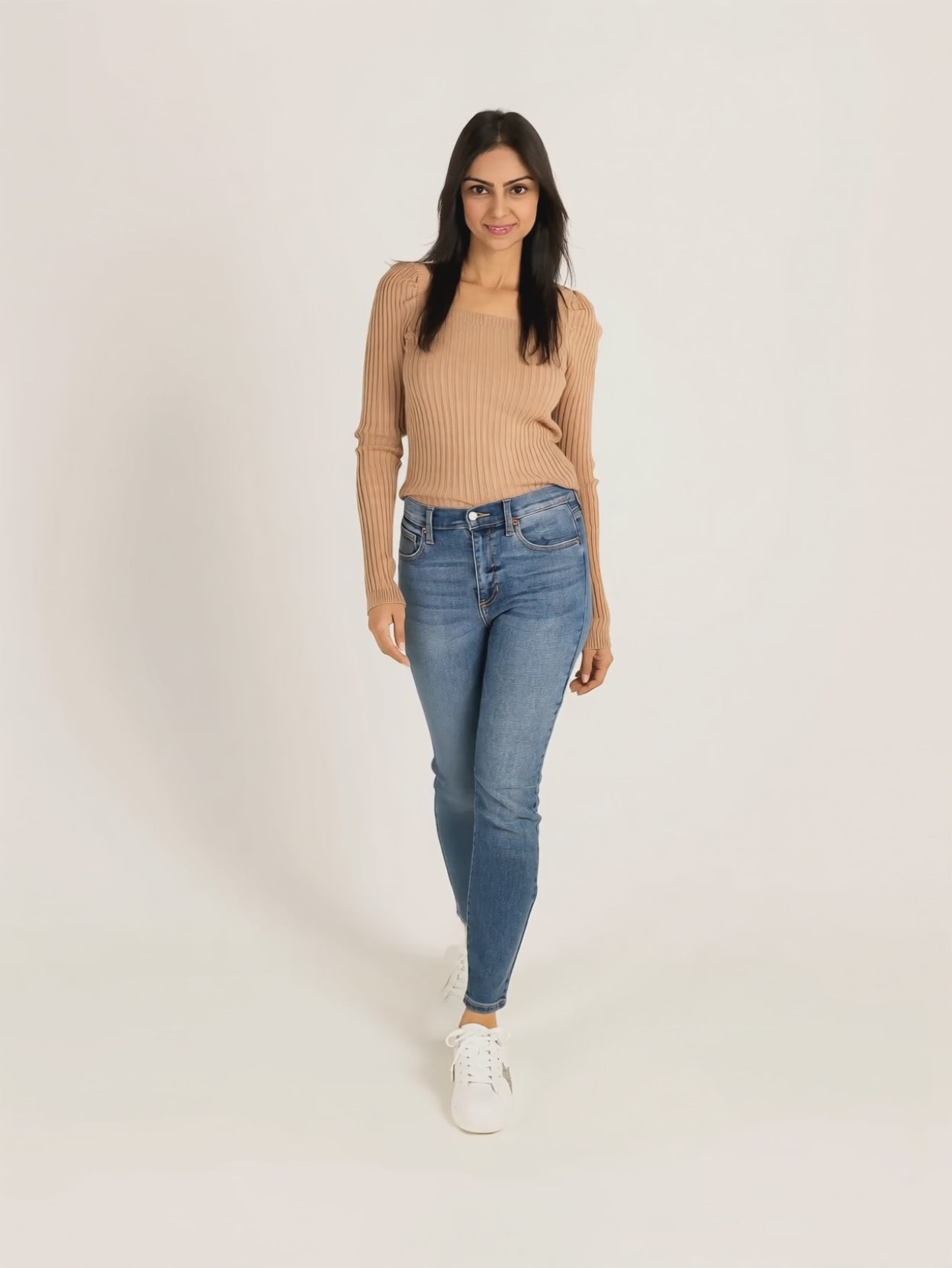 Shweta walks and turns in Bold Adventures skinny jeans, showing their fitted silhouette in motion.