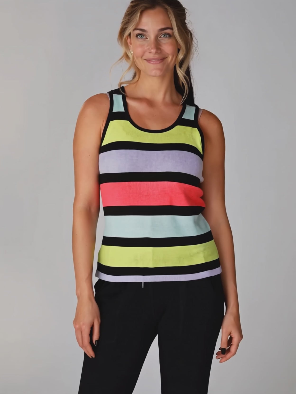Elsa subtly moving in the Calm Down Striped Tank Top while its front fit stays visible.