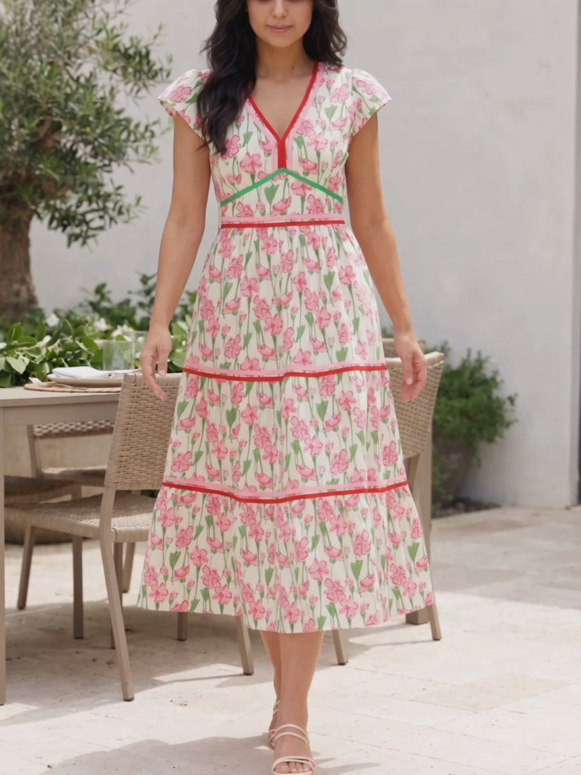 The floral poplin tiered dress swishing as Shweta walks through a brunch patio.