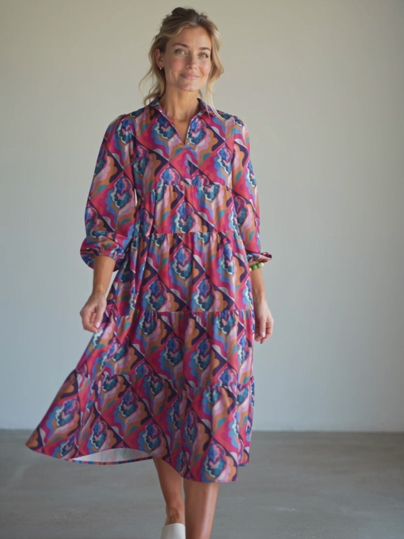 Calling You maxi dress in motion from the front, showing the fluid sweep of its gathered tiers.