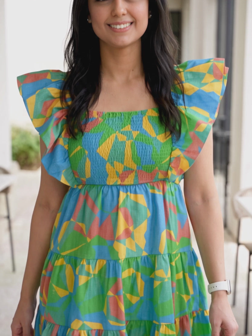 Shweta walking in the flutter sleeve mini dress as the tiered skirt and shoulder ruffles move.