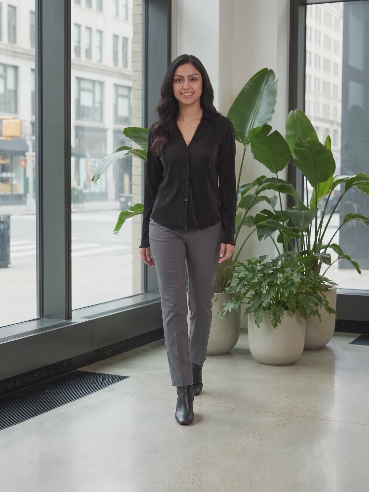 Rolling in the Deep Pleated Top worn by Shweta at a modern office lobby, stepping forward and turning to show the back and the fit.