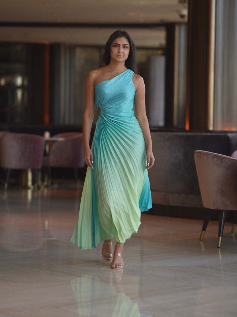 Ombre pleated dress moving through a cocktail setting as the skirt opens and settles.