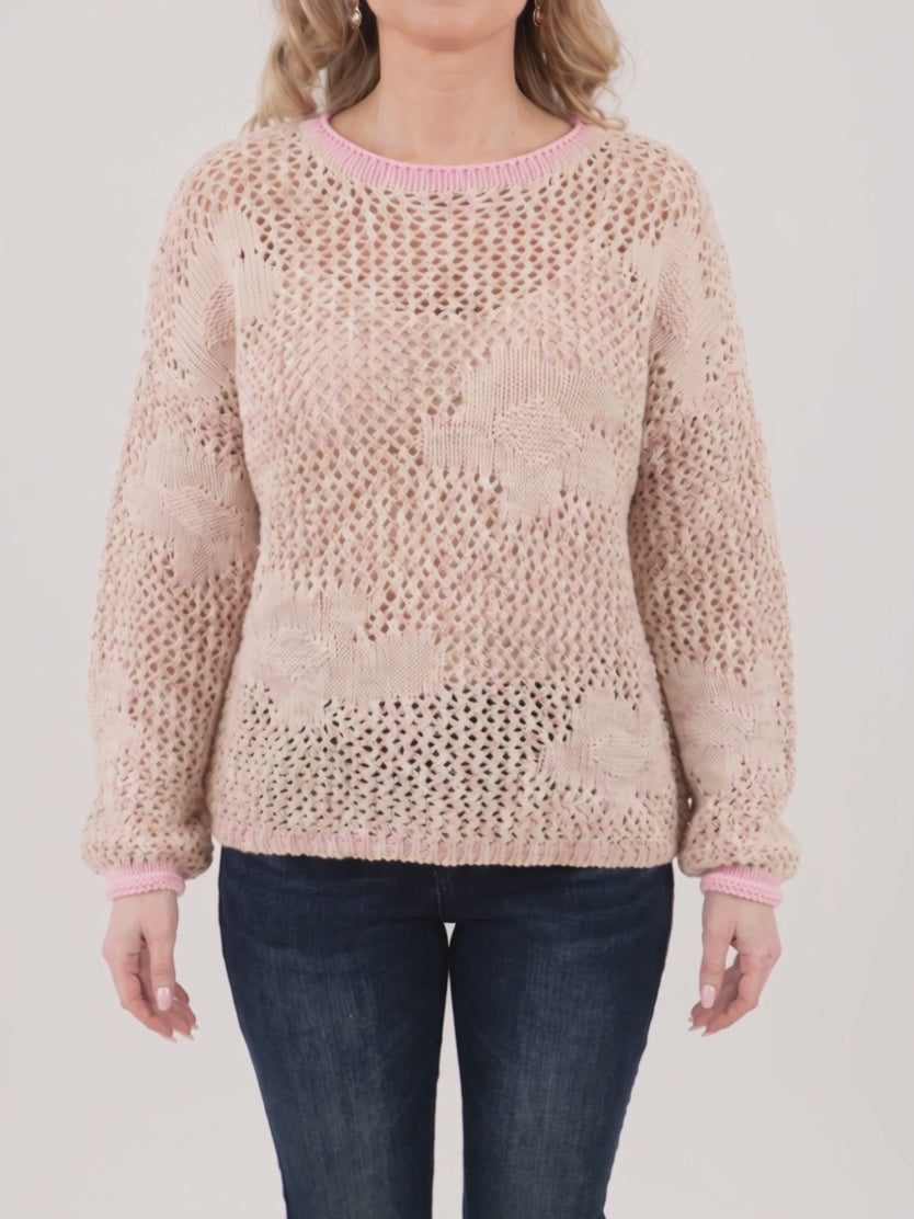 Elsa wearing the Small/Pink Flower Power Floral Sweater as its open-knit body and blouson sleeve move gently.