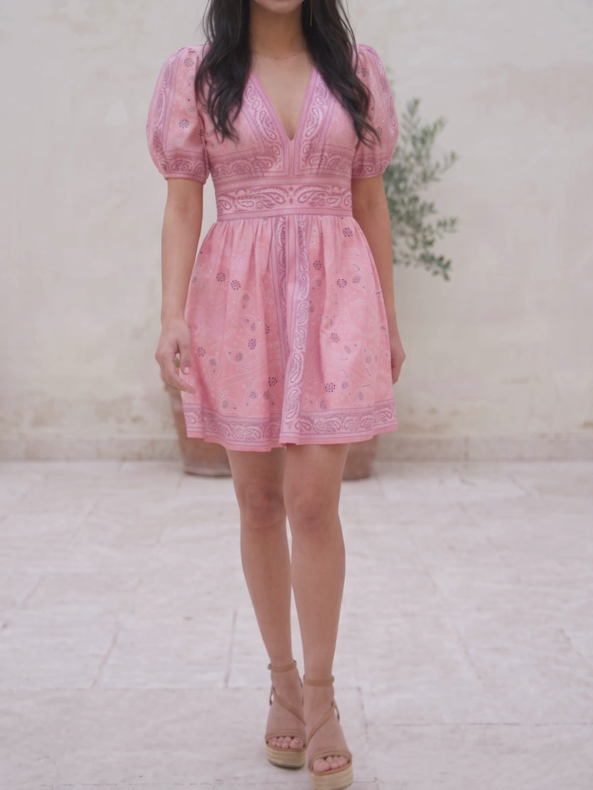 Forget Me Not Paisley Dress in motion, showing the puff sleeves and gathered mini skirt during a terrace walk.