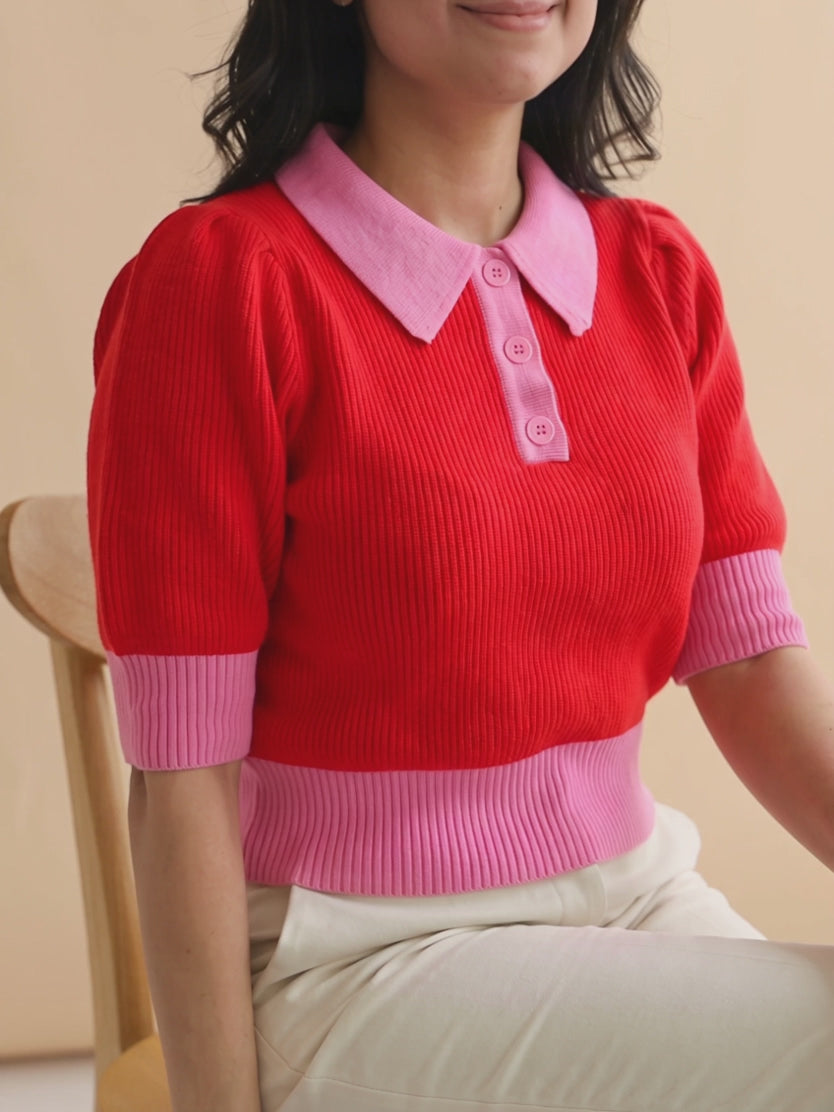 Shweta moves while seated in the sweater, showing how its sleeves and fitted waistband behave.