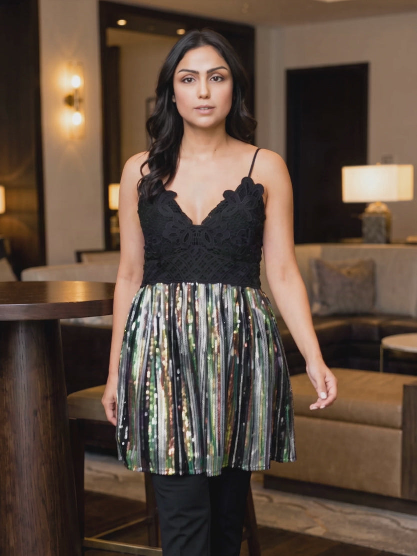 Small sequin tunic top moving as the flared mesh sways and the multicolour sequins catch the light.
