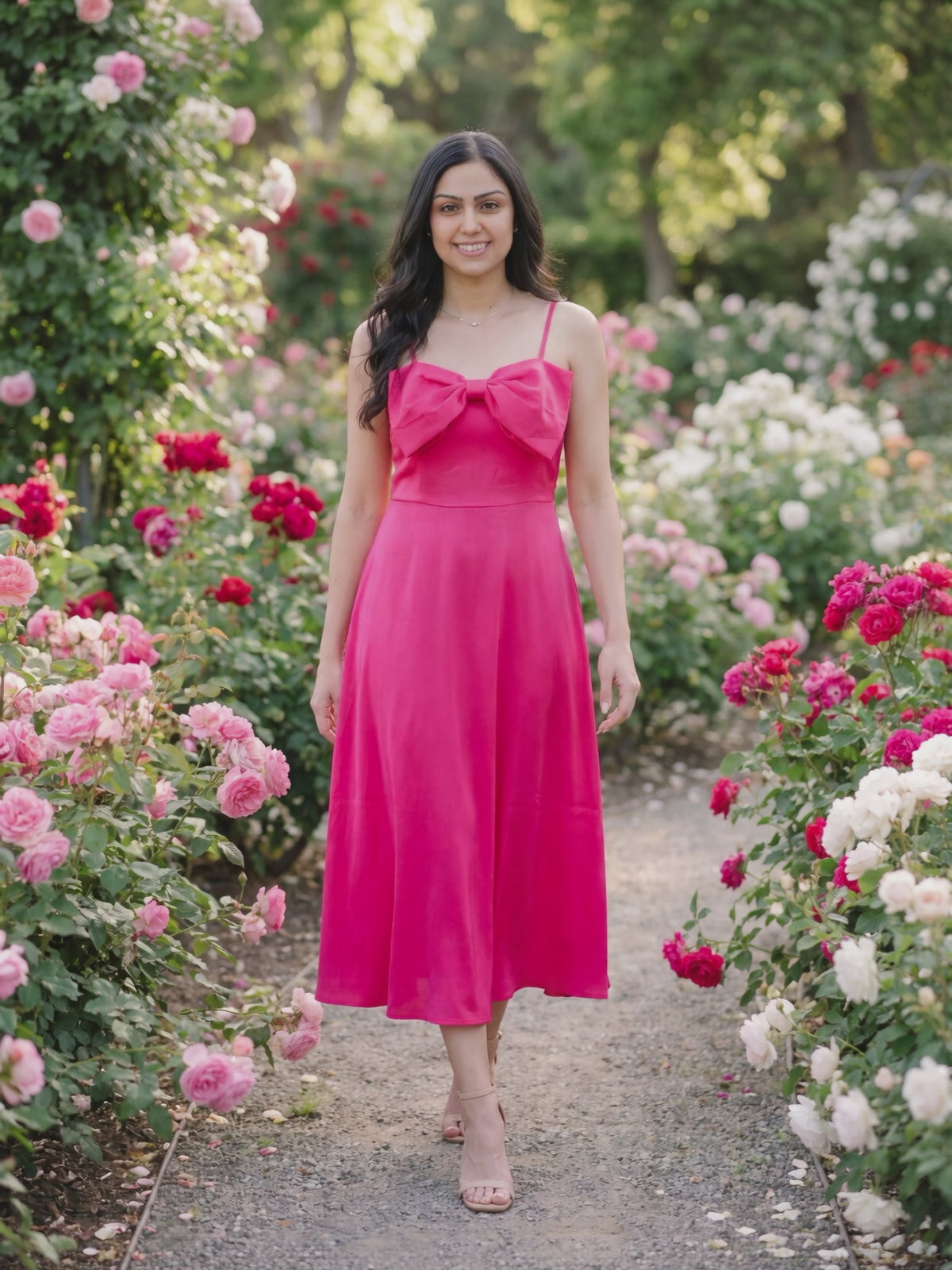 Bow-tiful You Midi Dress worn by Shweta at a rose garden, stepping forward and turning to show the back and the fit.