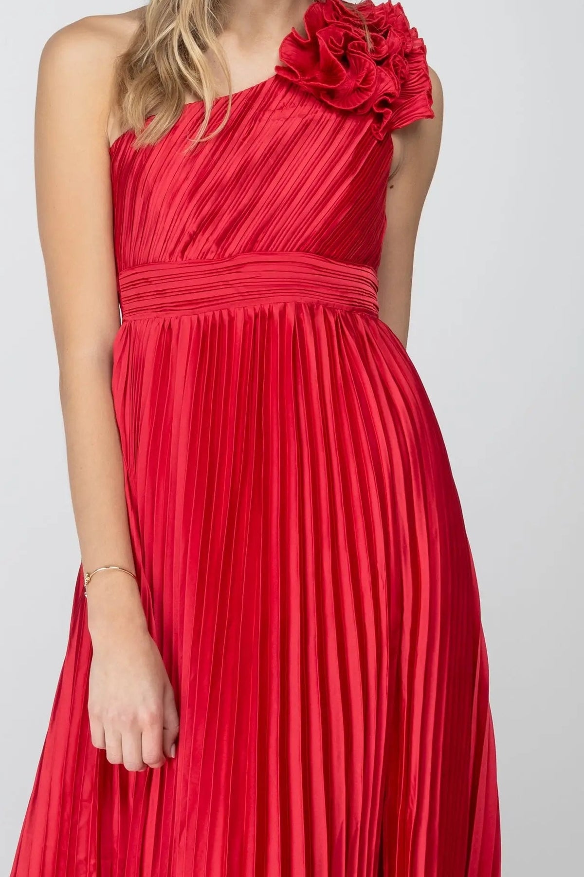 Close-up of the ruffle rosette, pleated satin bodice and banded waist of the red One More Night maxi dress