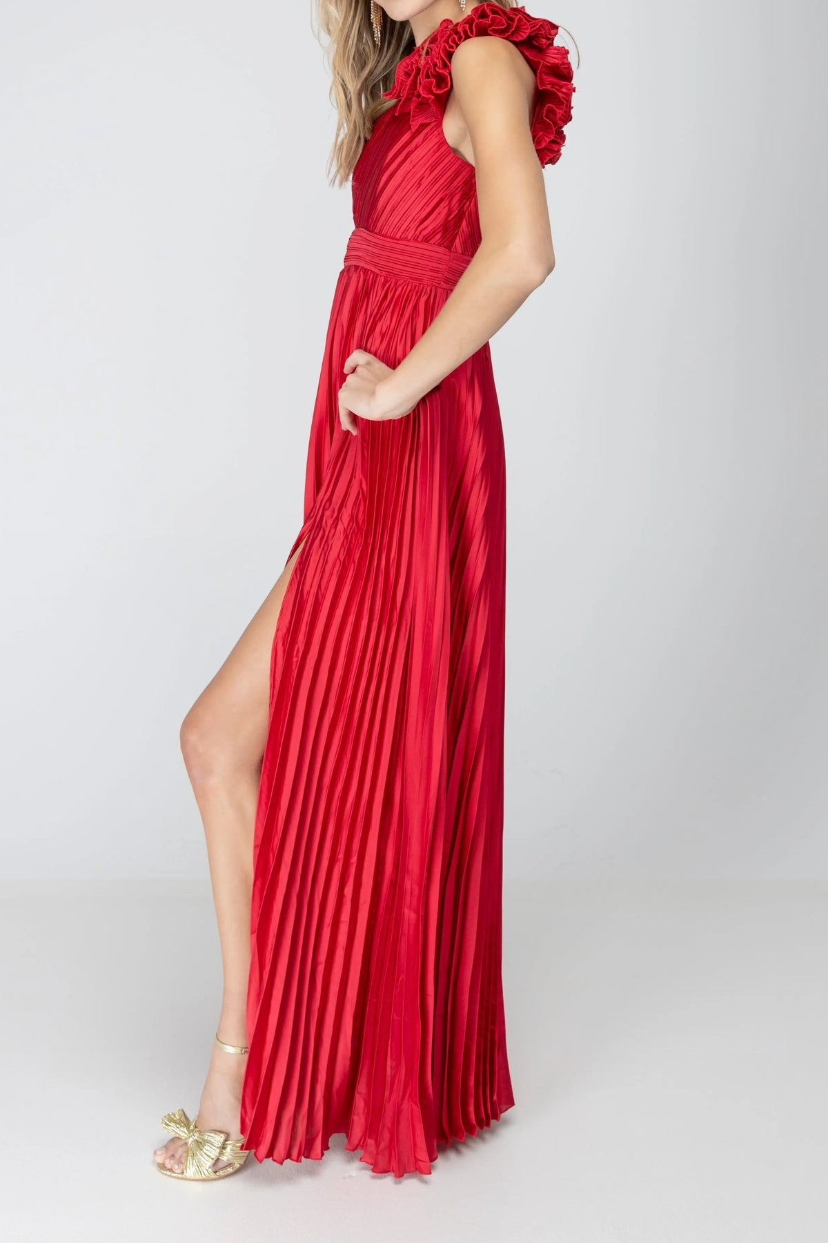 Side view of the One More Night maxi dress in Red, showing the shoulder rosette, pleats and leg slit