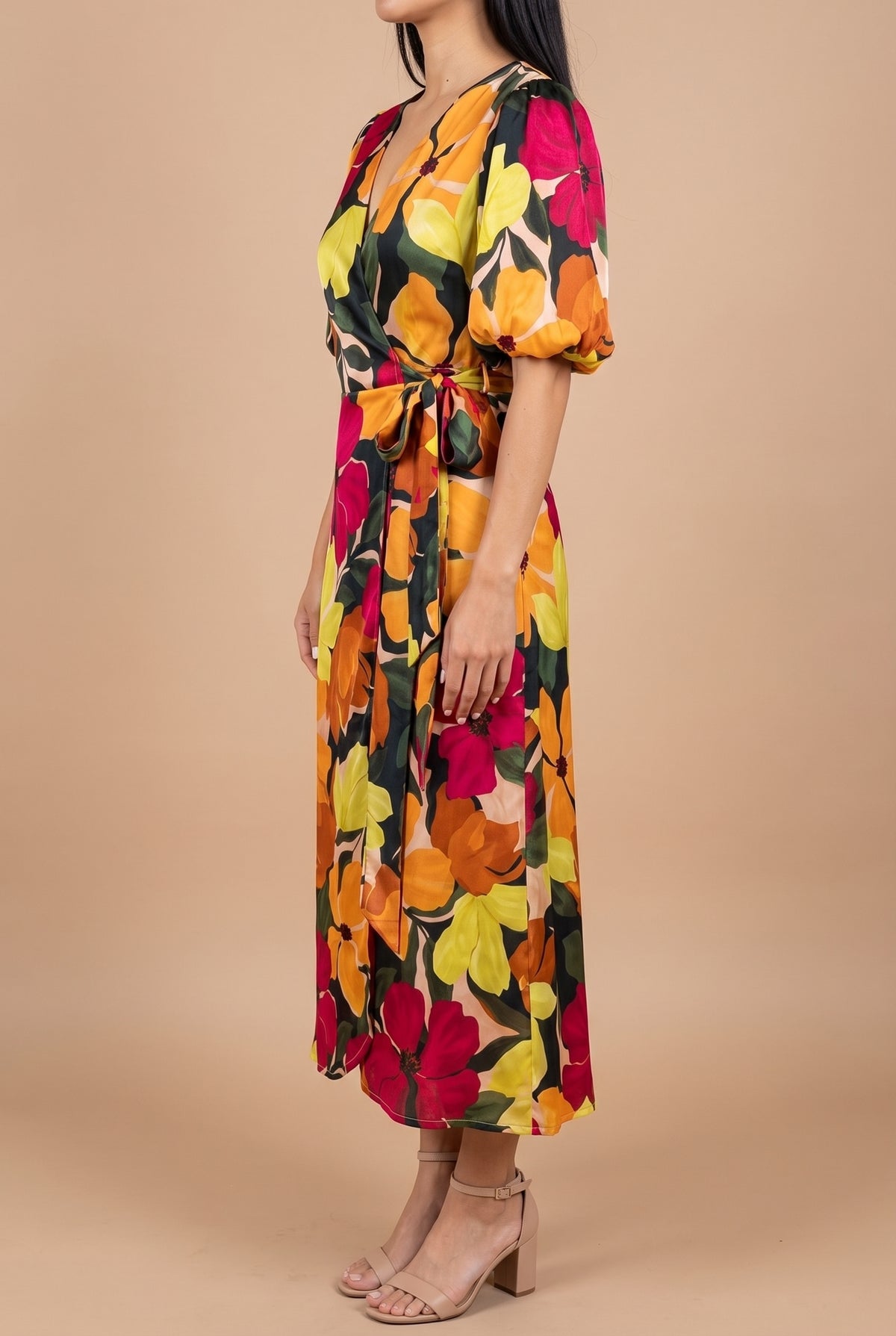 Side view of the If You're Not the One floral wrap midi dress, showing the bubble sleeve, the tie at the hip and how the skirt falls.