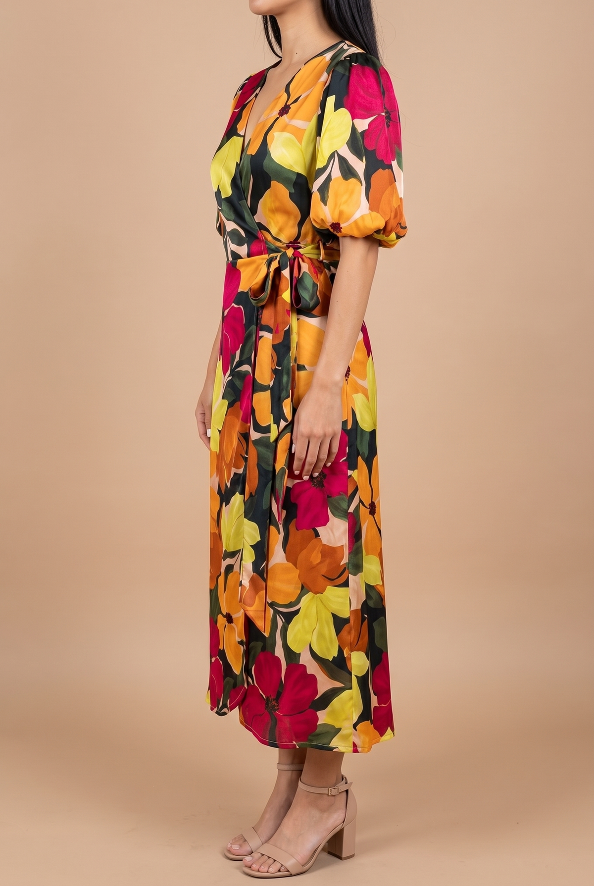Side view of the If You're Not the One floral wrap midi dress, showing the bubble sleeve, the tie at the hip and how the skirt falls.