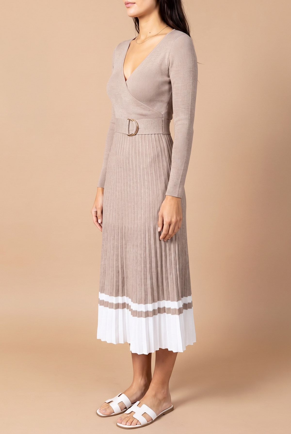 Side view of the I've Loved You For So Long pleated sweater dress, showing the wrap V-neck, belt buckle and pleats.