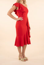Side view of the Scarlet Sway red one-shoulder ruffle midi dress, showing the shoulder ruffle and the cascading ruffle down to the hem.