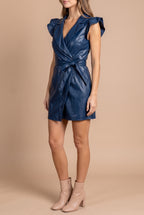 Side view of the Whenever Wherever navy faux leather wrap dress, showing the wrap front and the bow at the hip.