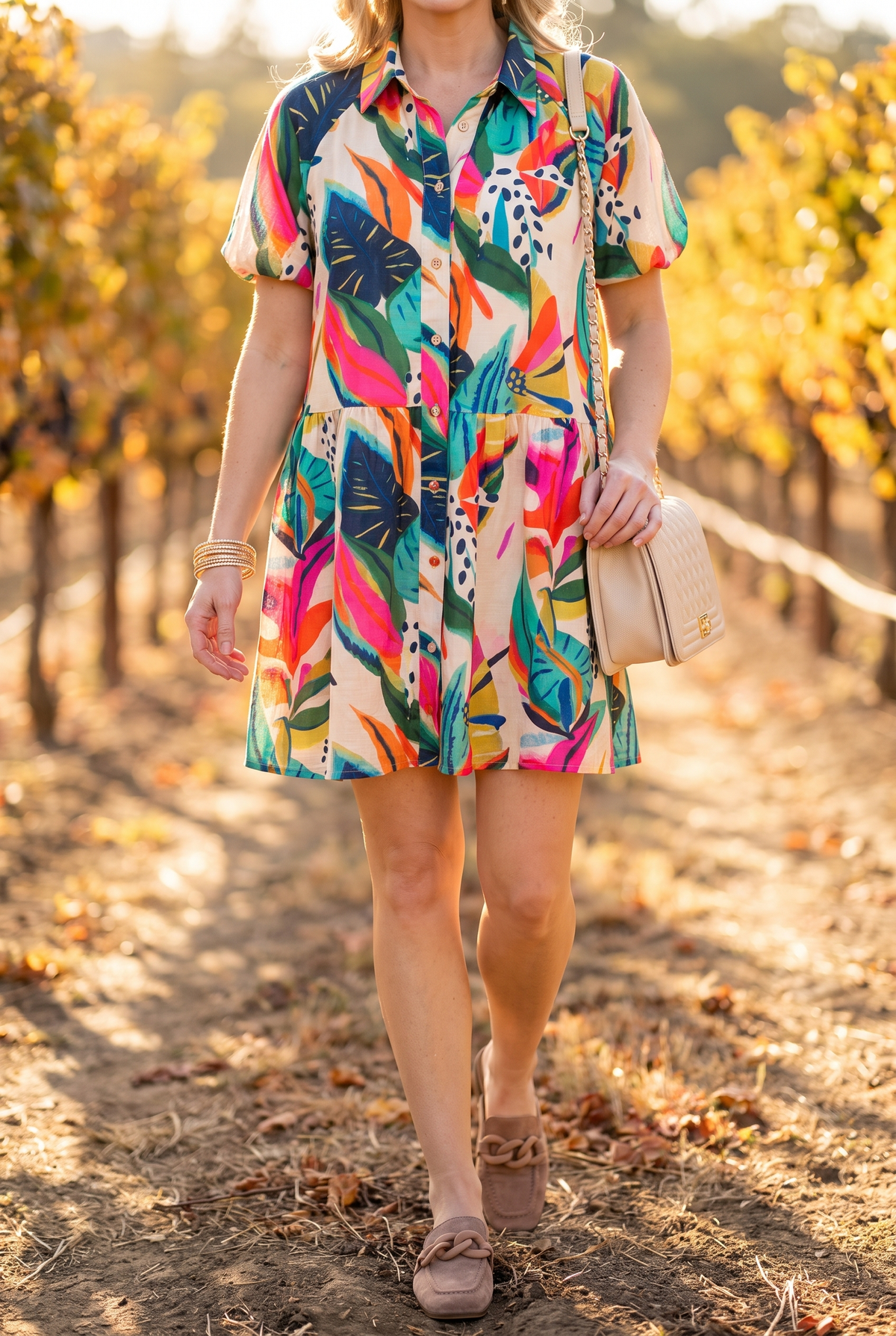 Sunset Swing tropical shirt dress in an autumn vineyard with the Charlotte chain mules, the Jacqueline quilted bag and Nora gold bangles