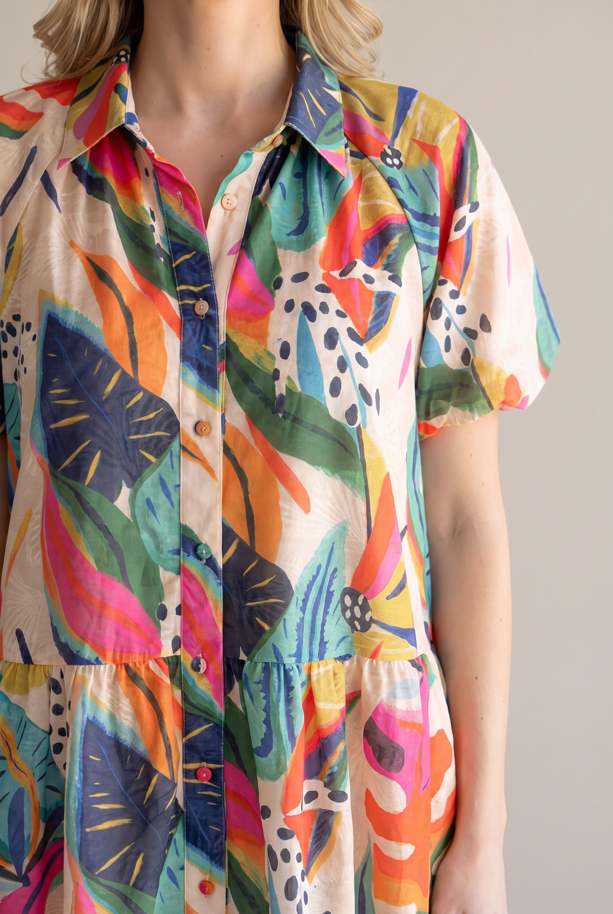 Close-up of the Sunset Swing tropical leaf print, collar, button placket, puff sleeve and dropped gathered waist