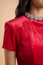 Close-up of the ruby red rhinestone neckline velvet mini dress, showing the velvet and the finishing details.