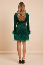 Back view of the green velvet feather trim long sleeve mini dress.