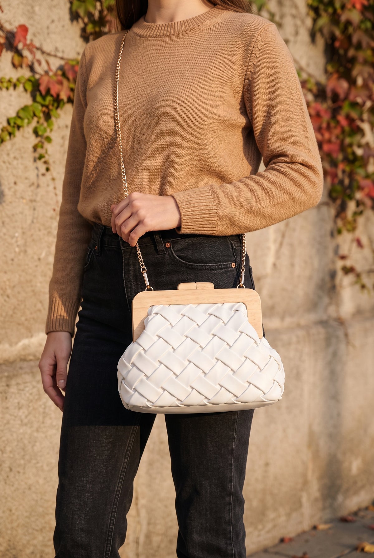 Nova Woven Clutch in White worn on its gold chain at the hip, shown at true size