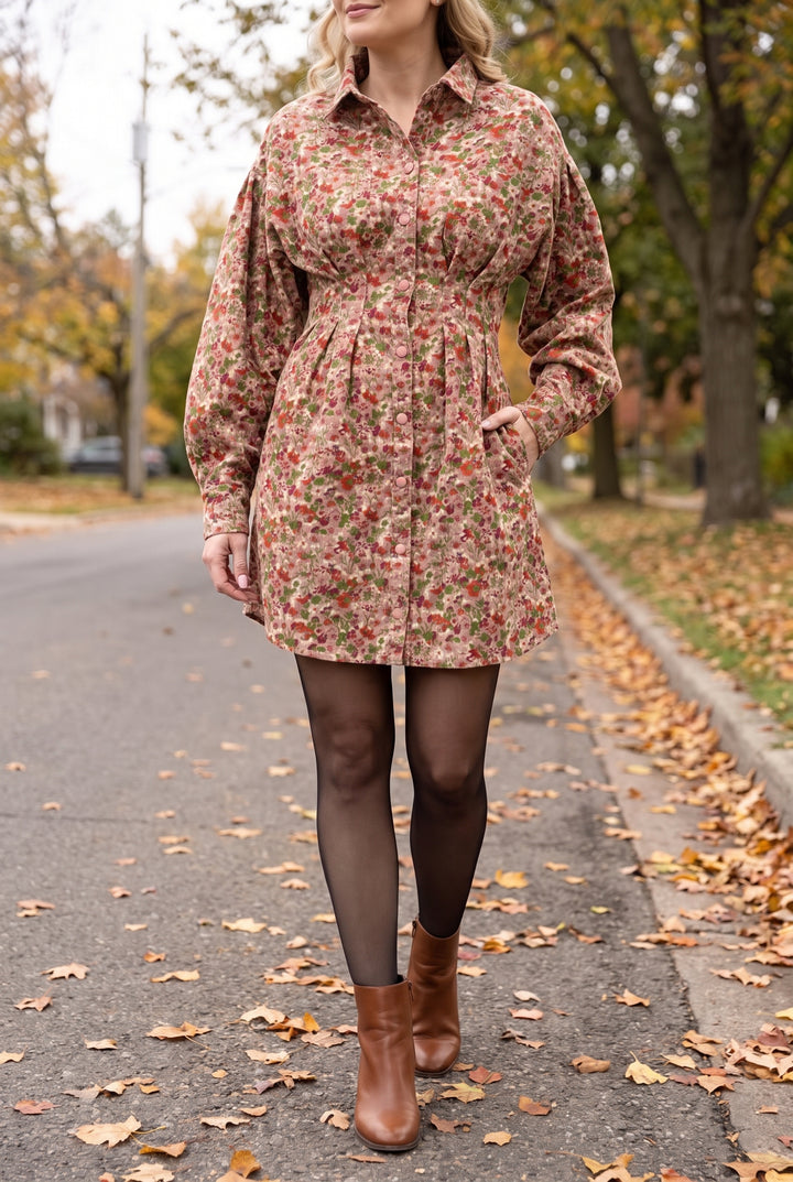 Woman on an autumn street wearing the floral corduroy mini dress with black tights and brown boots