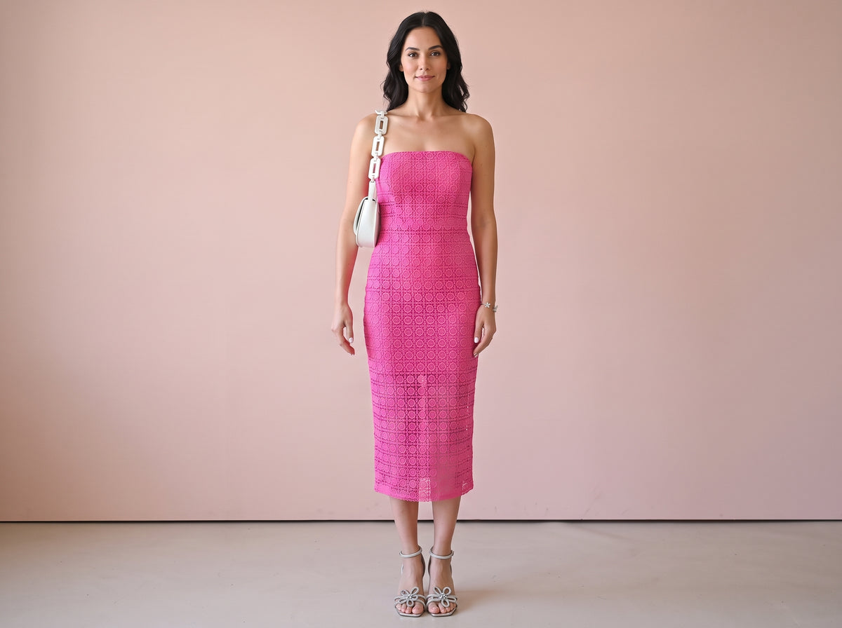 Woman wearing a silver butterfly bracelet, a pink strapless lace midi dress, silver flower ankle-strap sandals and a white chain shoulder bag