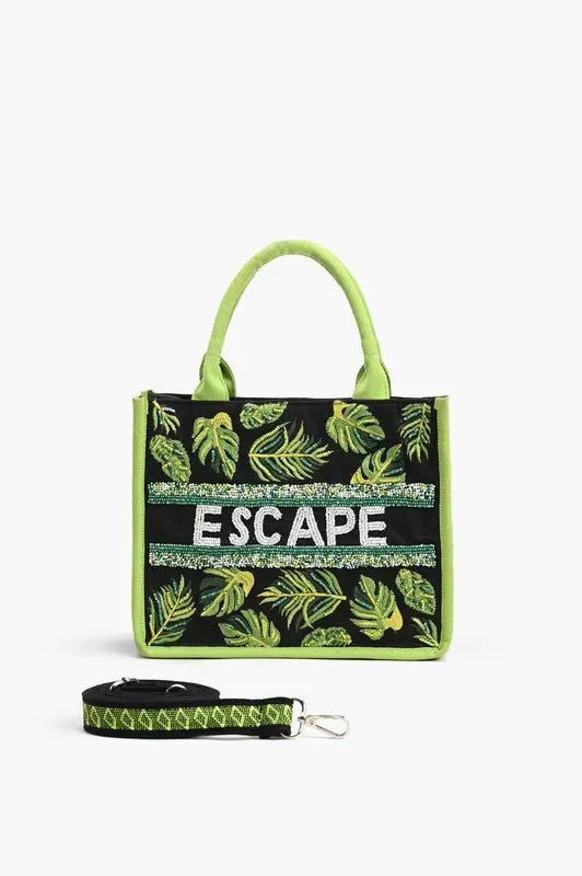 A tropical-themed tote bag featuring green leaf embroidery, sequin "ESCAPE" lettering, fabric-wrapped handles, and a detachable crossbody strap.