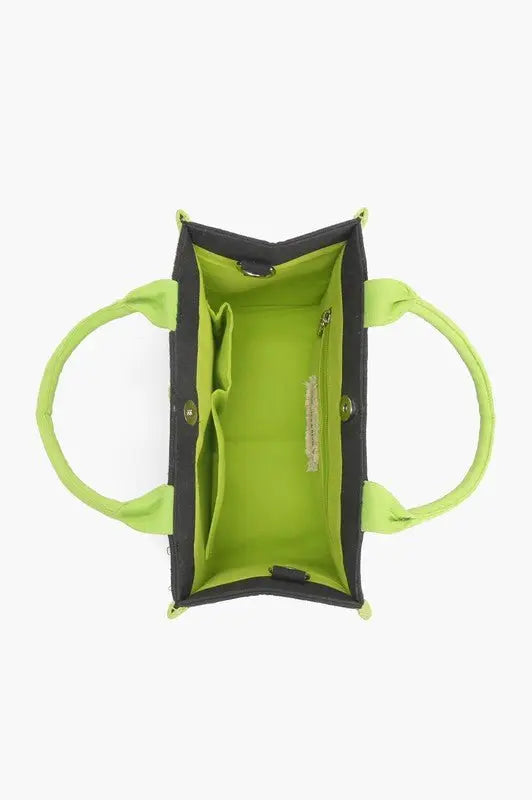 A tropical-themed tote bag featuring green leaf embroidery, sequin "ESCAPE" lettering, fabric-wrapped handles, and a detachable crossbody strap.