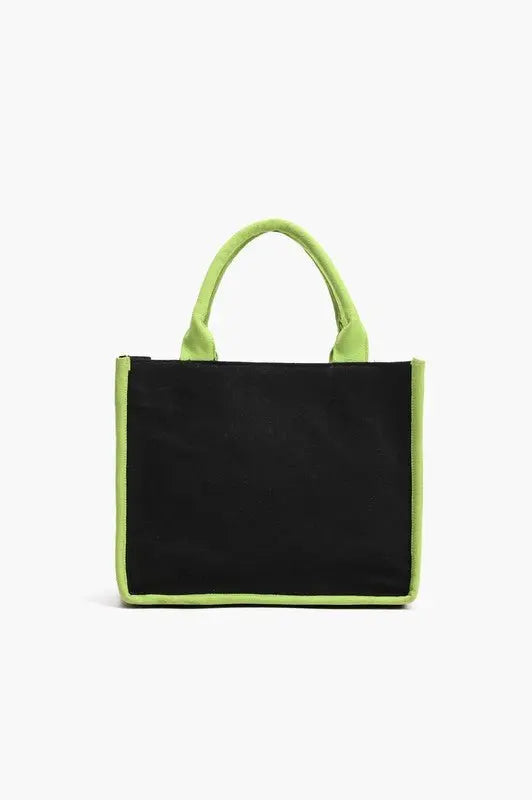 A tropical-themed tote bag featuring green leaf embroidery, sequin "ESCAPE" lettering, fabric-wrapped handles, and a detachable crossbody strap.